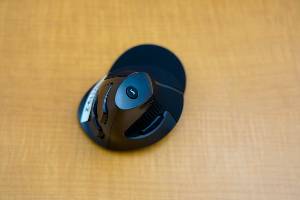 black computer mouse with buttons sitting on desk