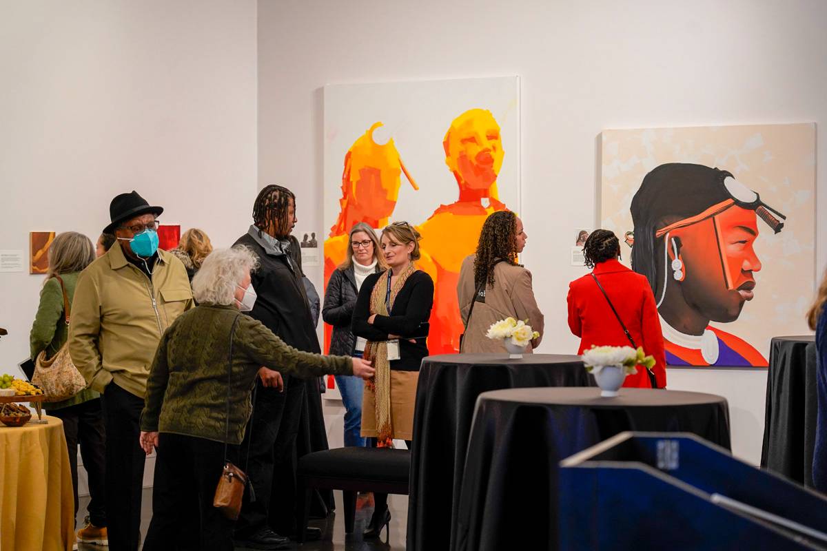 A group of people stand in the TCC art gallery 