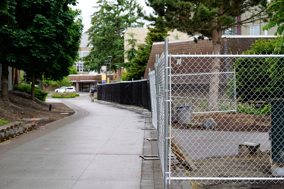 Campus walkway, looking towards Building 15, with a fence along the walkway blocking access to Building 10