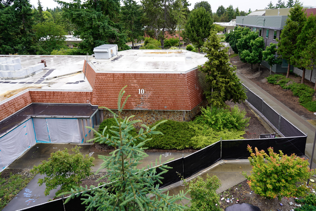 Building 10, fenced off, with the campus walkway, seen from the Building 13 roof deck 