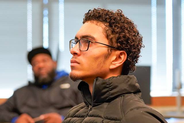 An accounting student looks attentively ahead in a classroom