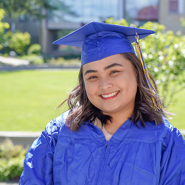 grad wearing blue regalia