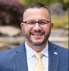 Man in a pink tie smiling