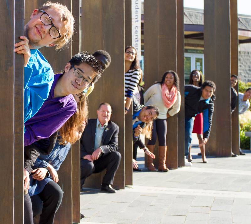 TCC students standing by the pillars in the Campus commons