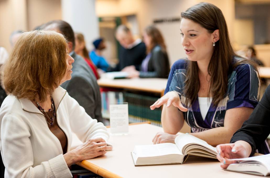 A student speaking to a faculty member at the library